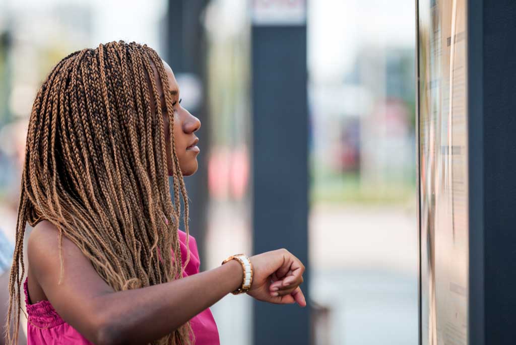 Photo of a woman looking at a timetable